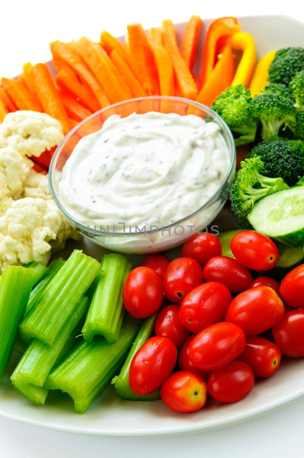 Platter of assorted fresh vegetables with dip