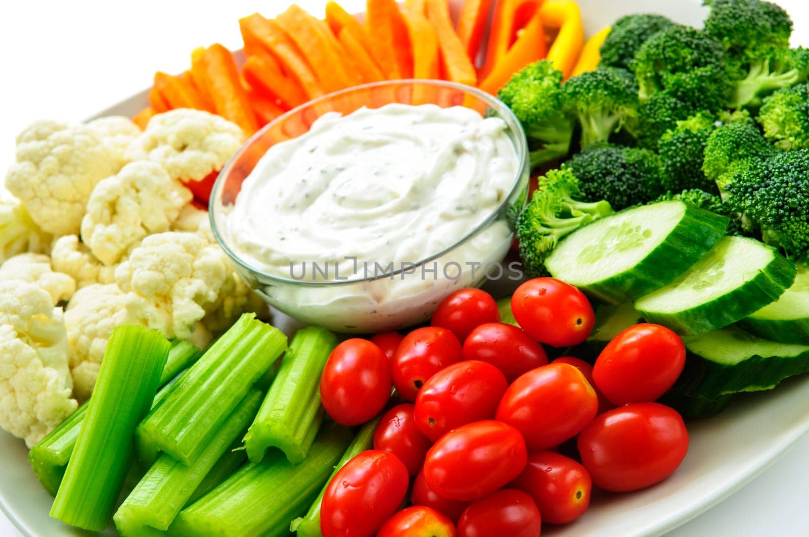 Platter of assorted fresh vegetables with dip