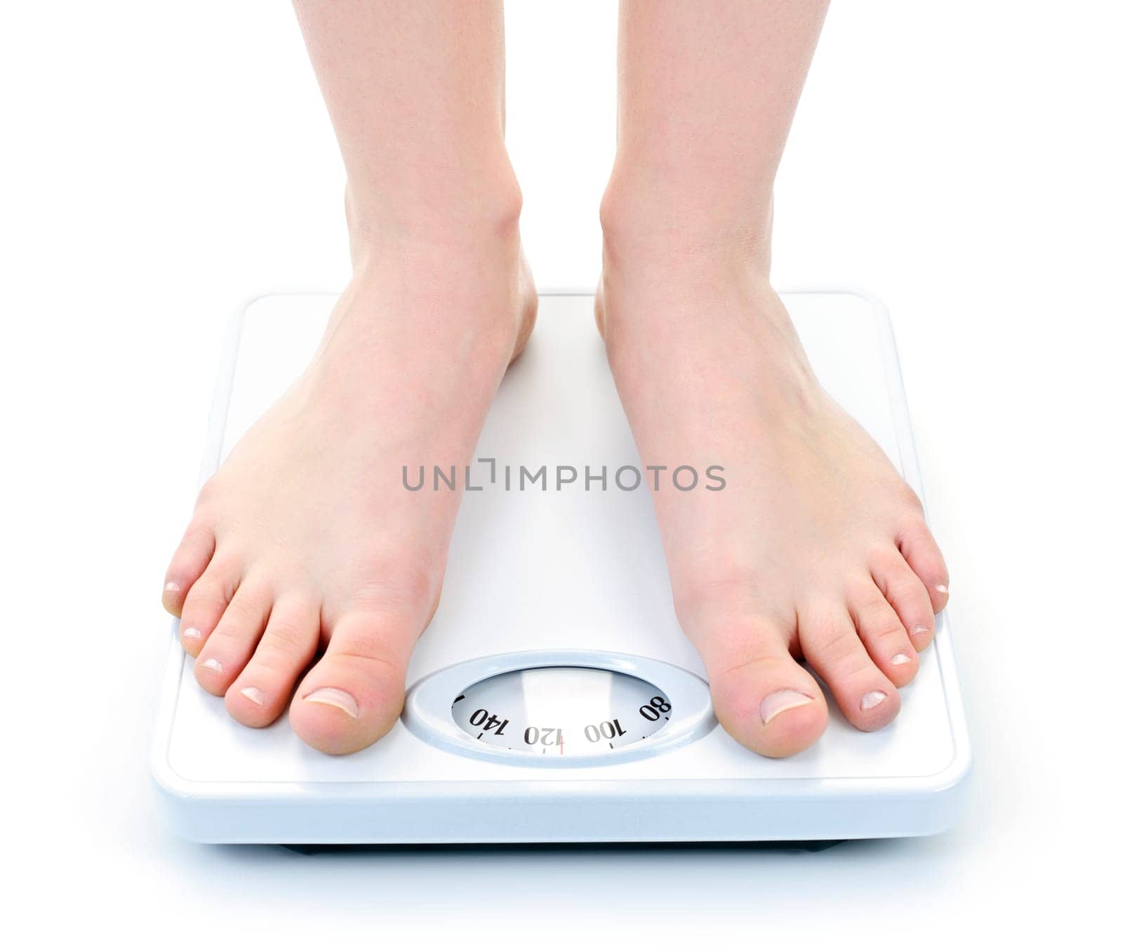 Bare female feet standing on bathroom scale