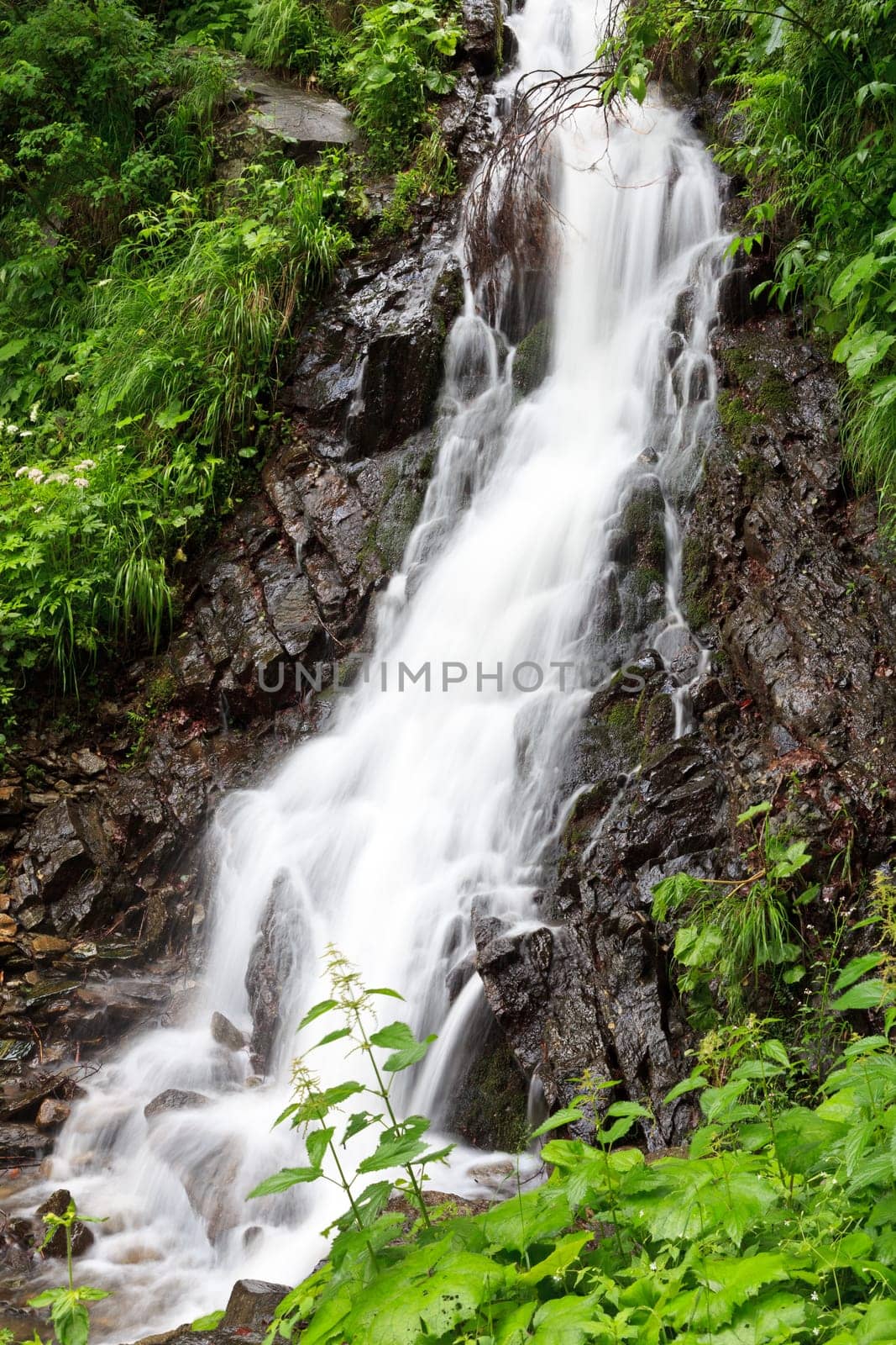 a beautiful waterfall on a mountain slope