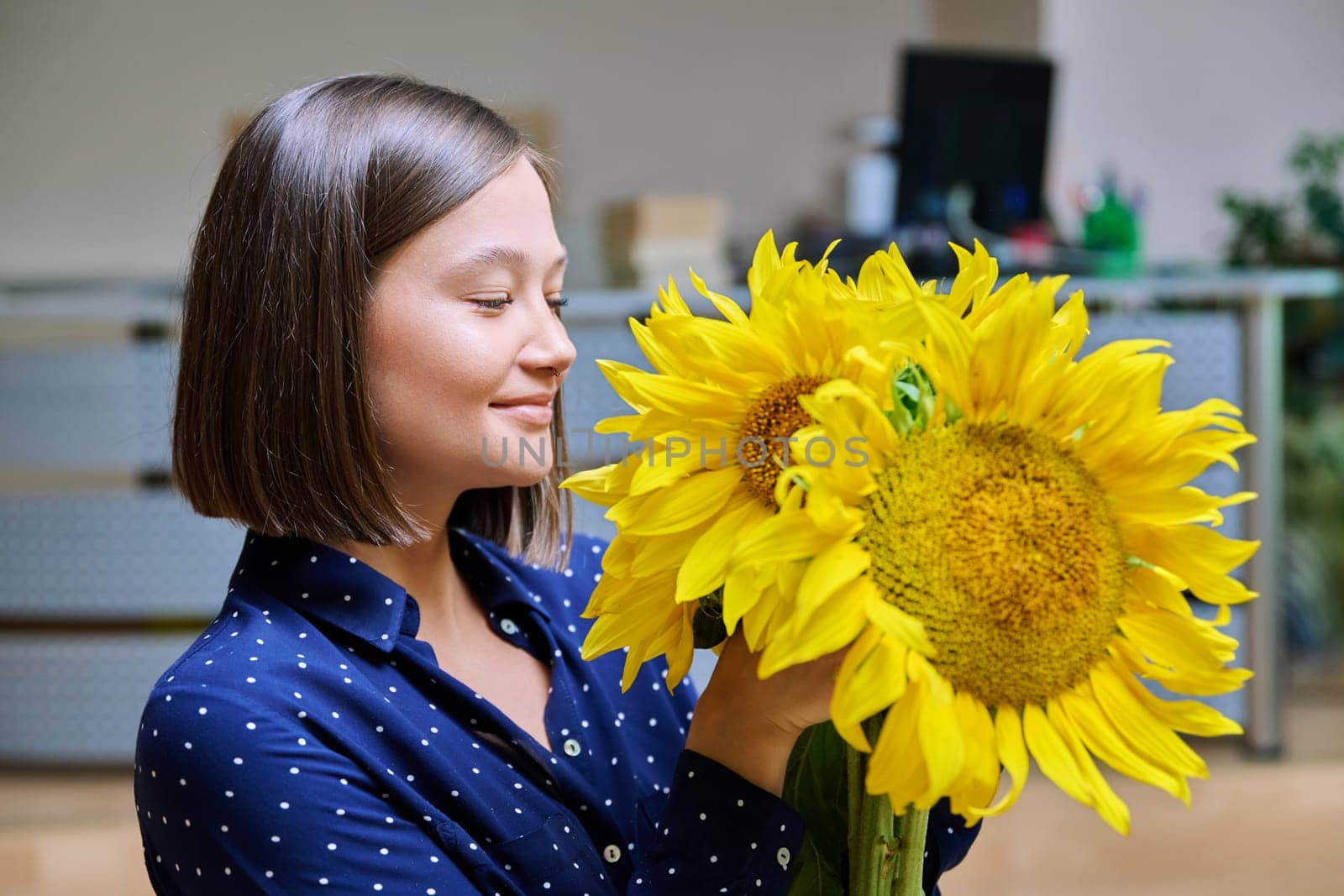 Young happy woman with bouquet of yellow sunflower by VH-studio
