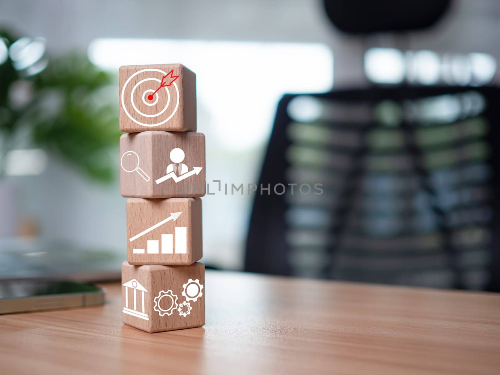 Wooden blocks and business icons on table wood represent the concept of business strategy and setting business goals. by Unimages2527