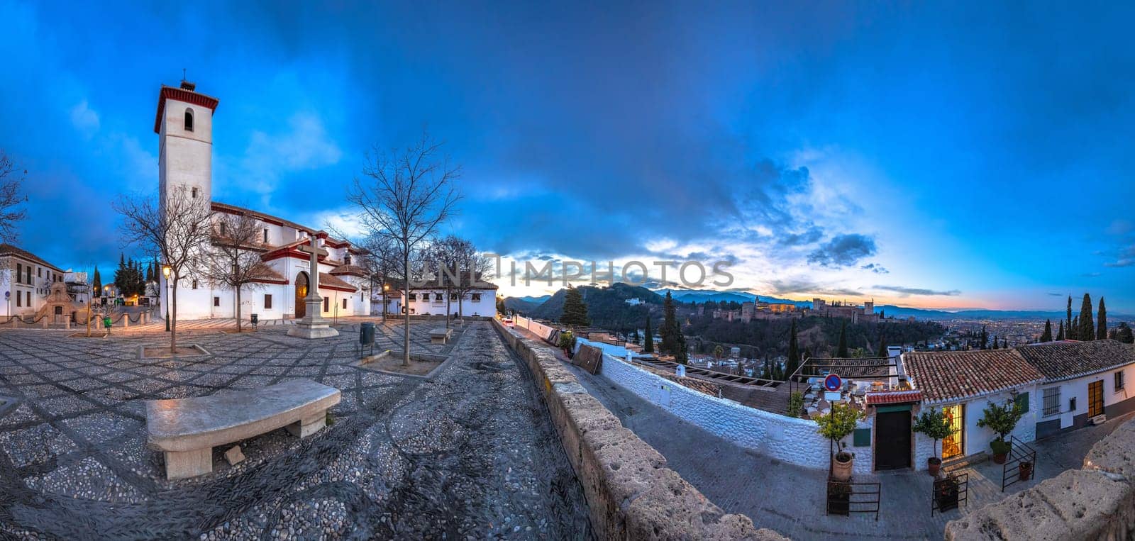 Granada. Ancient church and square in historic Albayzin and Alhambra panoramic view. Andalusia region of Spain