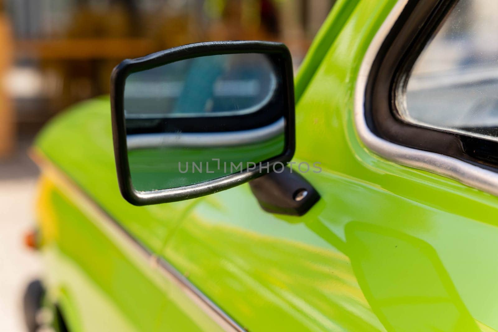 the side rearview mirror of an old classic car is light green. Details of retro cars