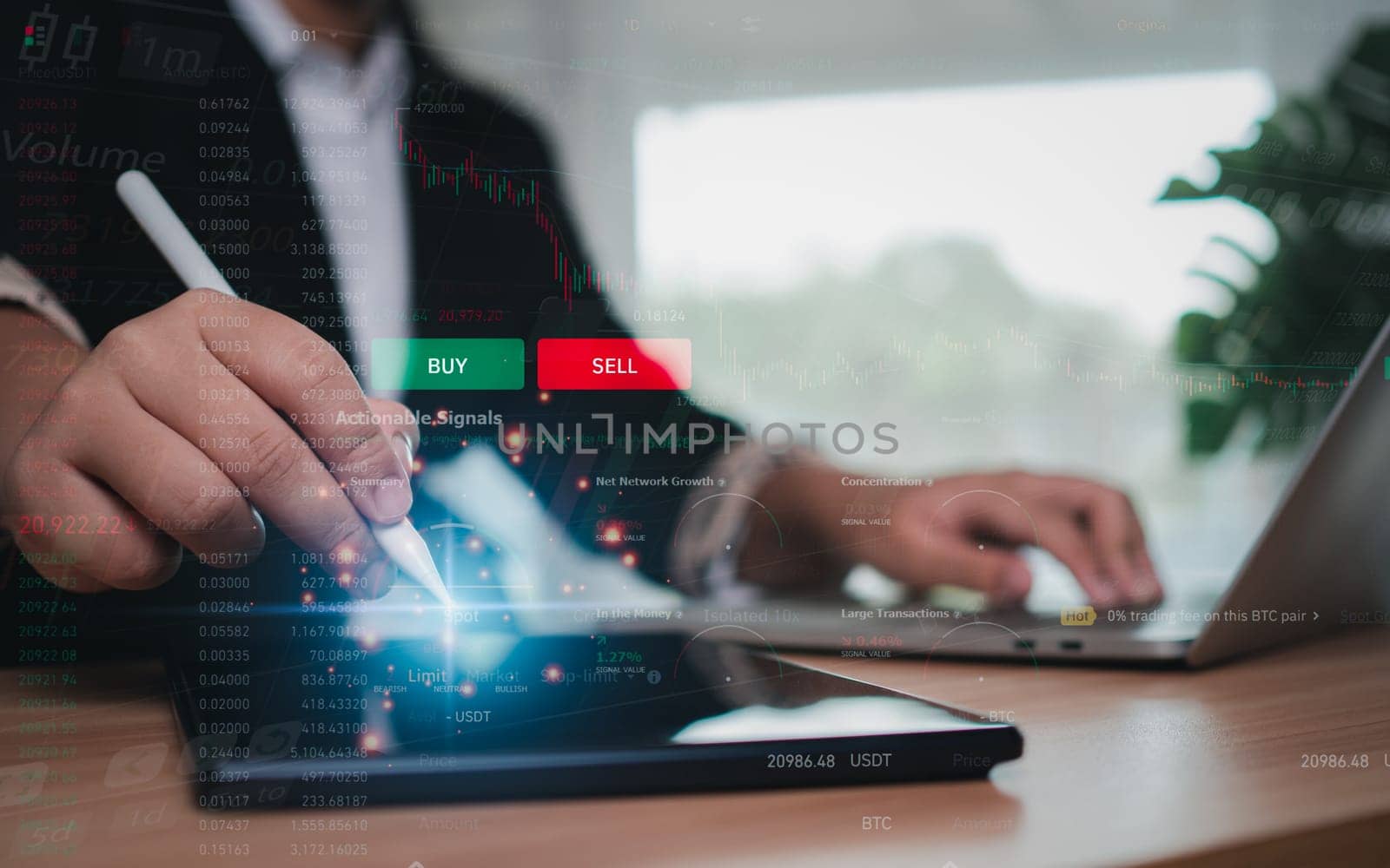 Businesswoman or trader is using a stylus pen pointing at a tablet showing trading and investing in the stock market. by Unimages2527