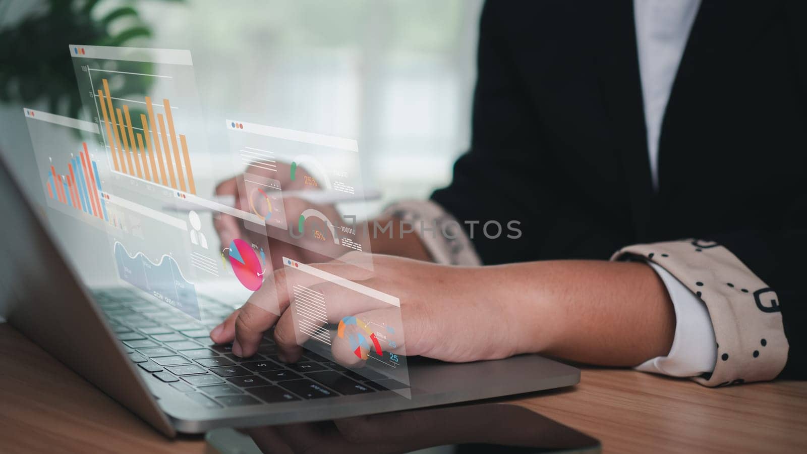 Business women use computers to analyze business and manage business data analysis as well as corporate data analysis with charts and indicators. by Unimages2527