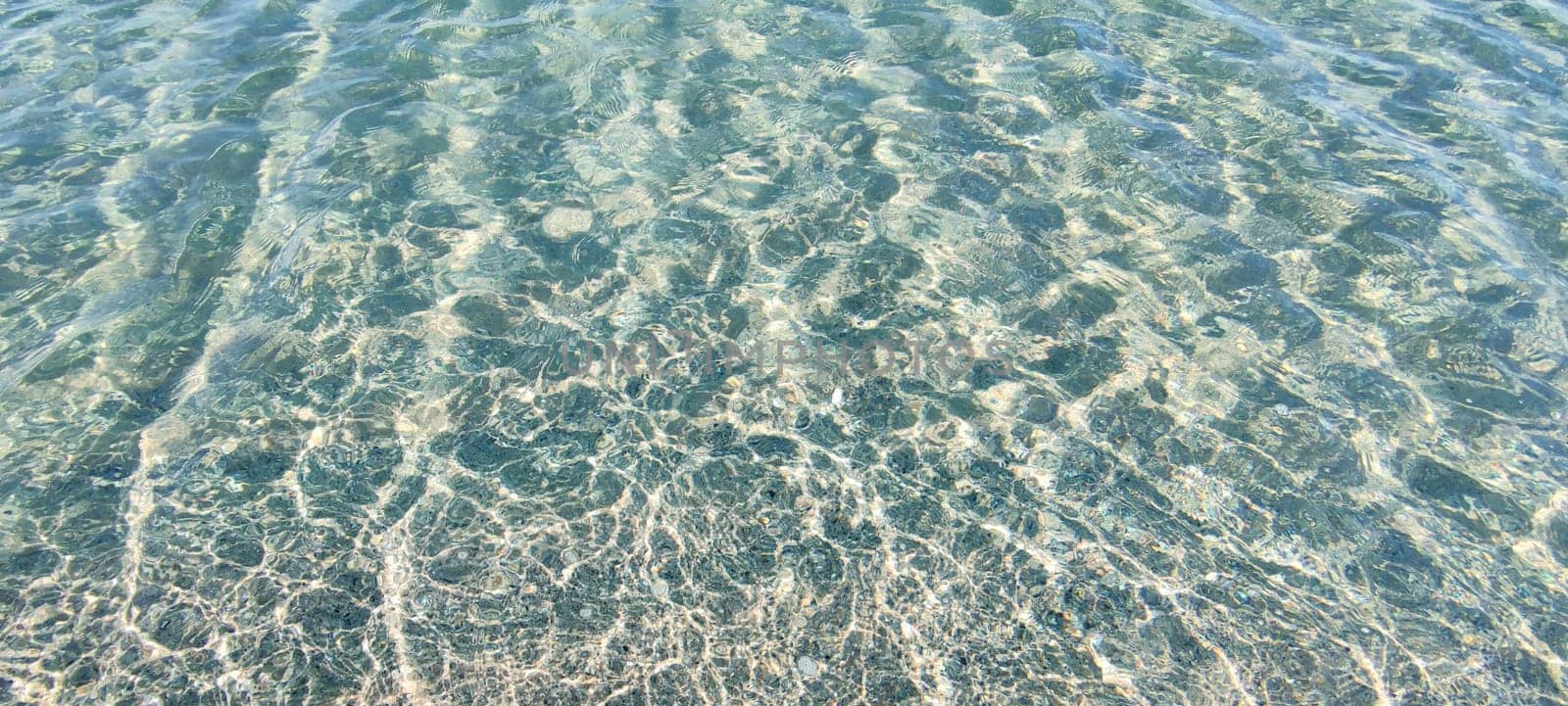 blue transparent water surface in which sunlight is reflected by Annado