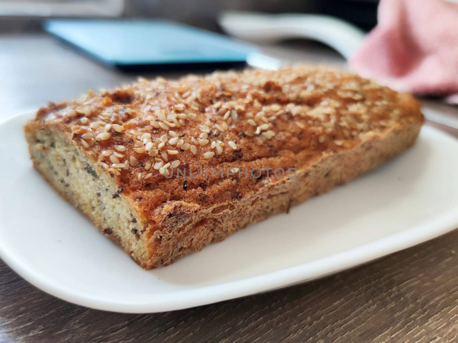 keto bread with seeds on a white plate in the kitchen close-up