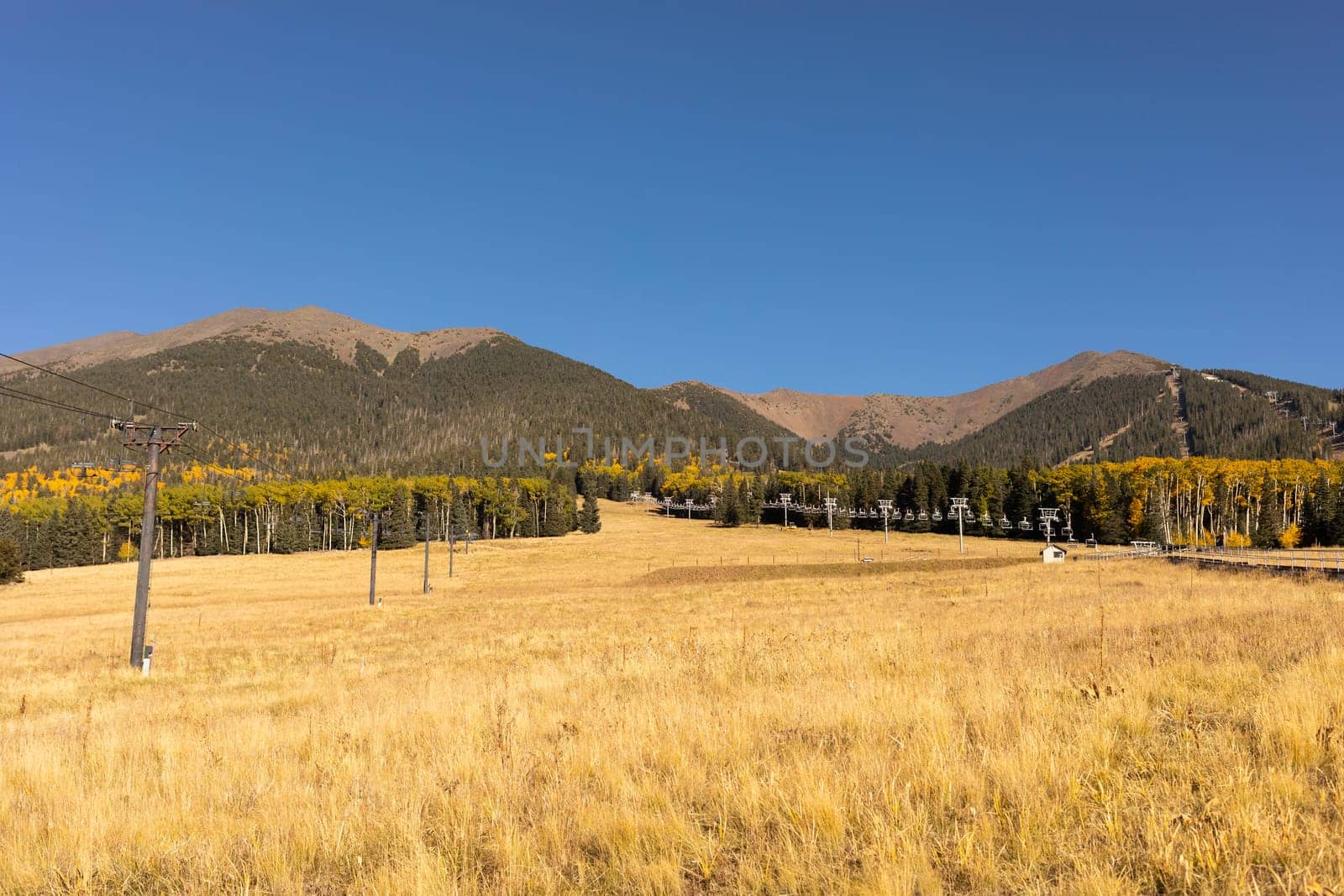Humphreys Peak in Flagstaff, Arizona. San Francisco Peaks Landscape in Fall Season on Blue Sky. Scenic Climbing, Hiking and Mountaineering in Autumn Season. Horizontal Plane. High quality photo