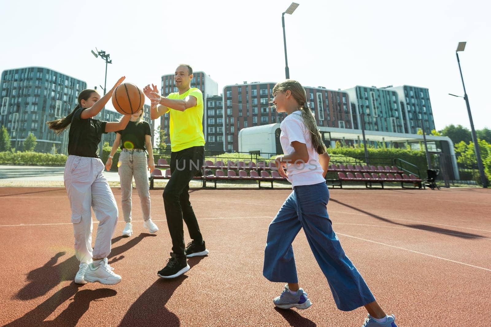 the family plays basketball on the court. High quality photo