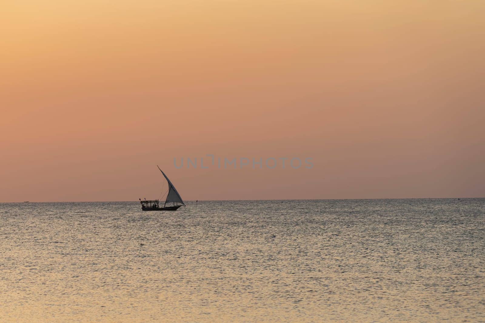 African boat sails in the ocean at sunset by Robertobinetti70