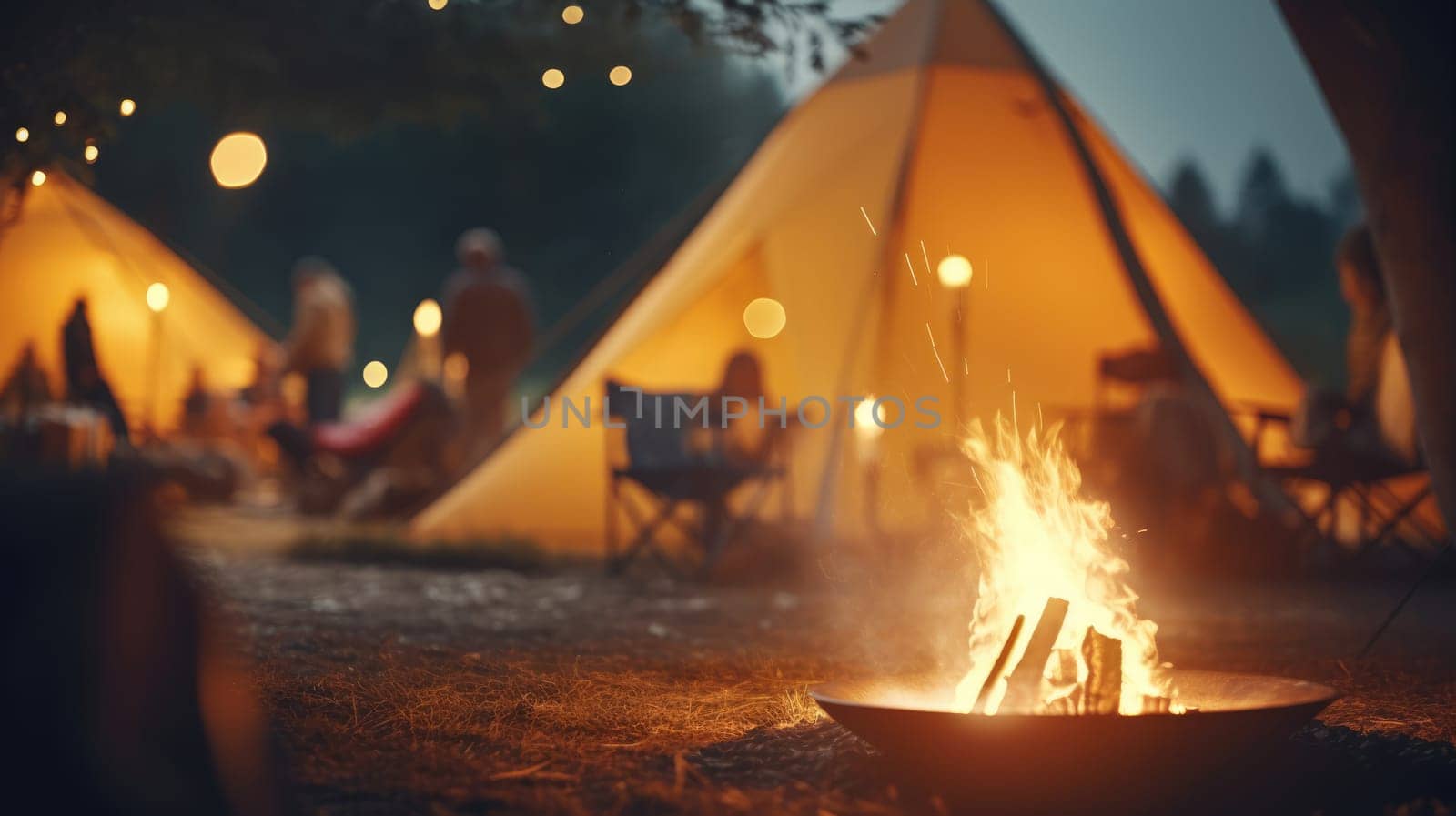 Picnic fire in focus. Blurred background with people and the yellow tent by natali_brill