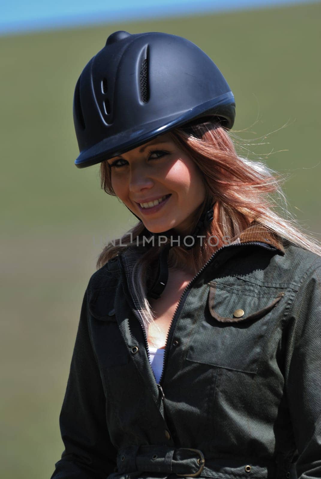 Young horseriding girl in safety hat