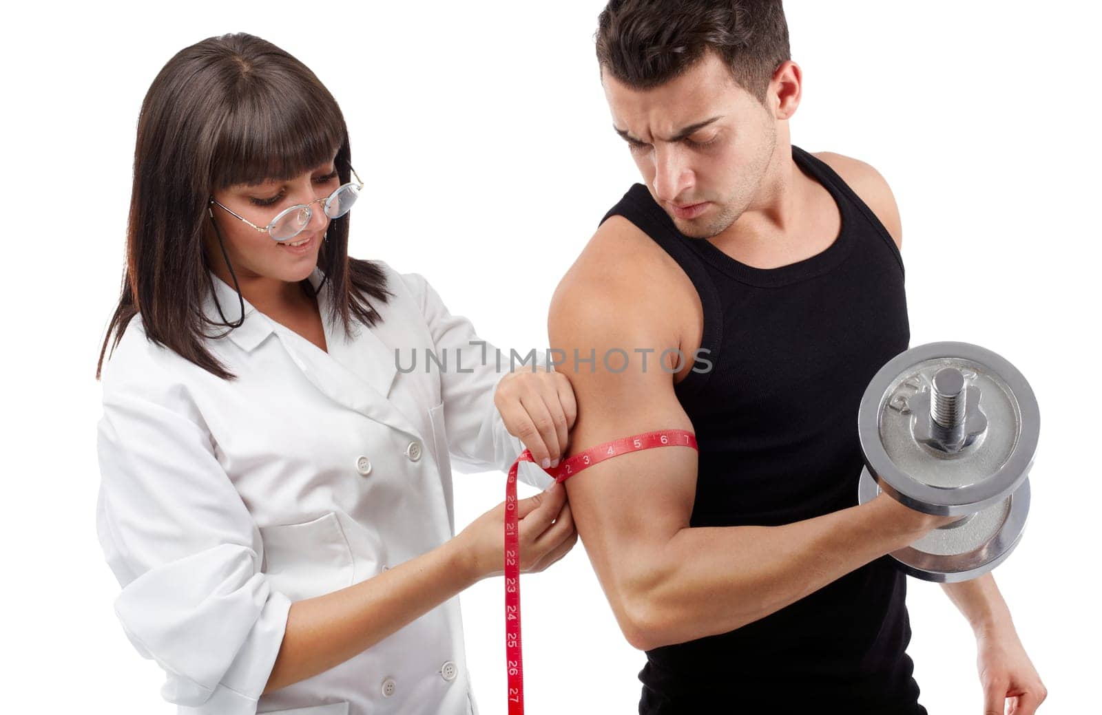 Pretty young nurse measuring the biceps of handsome man
