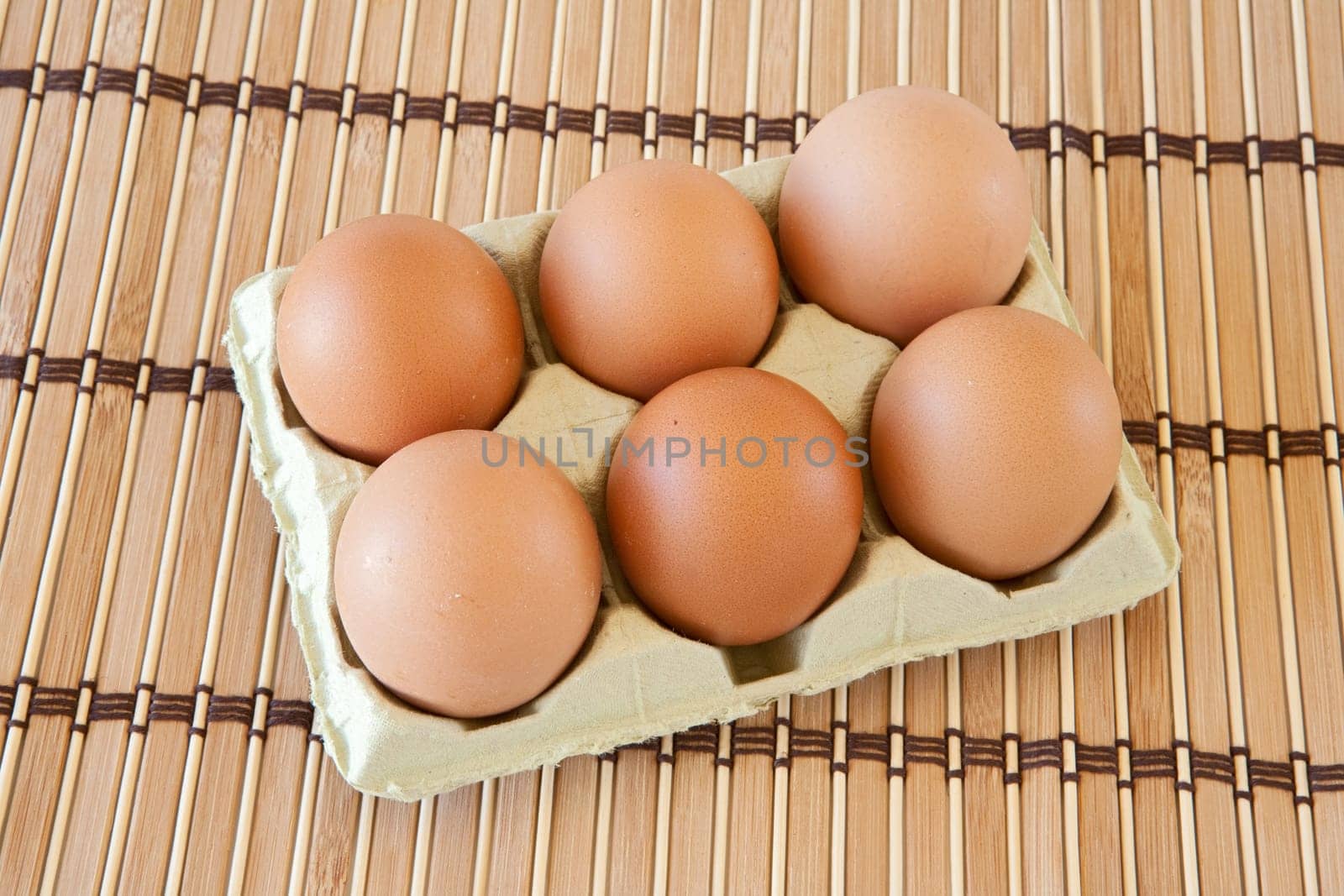 Photo of half dozen eggs on bamboo tablecloth
