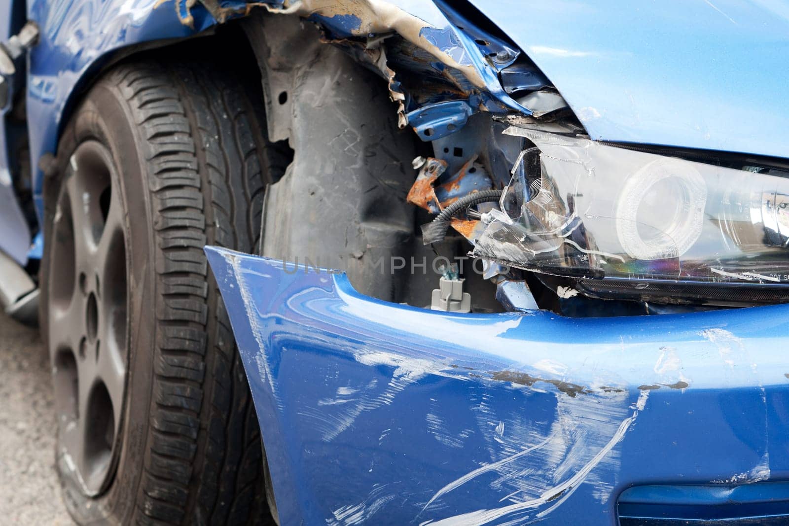 Accident with sheet metal damage,dented car stands on the road