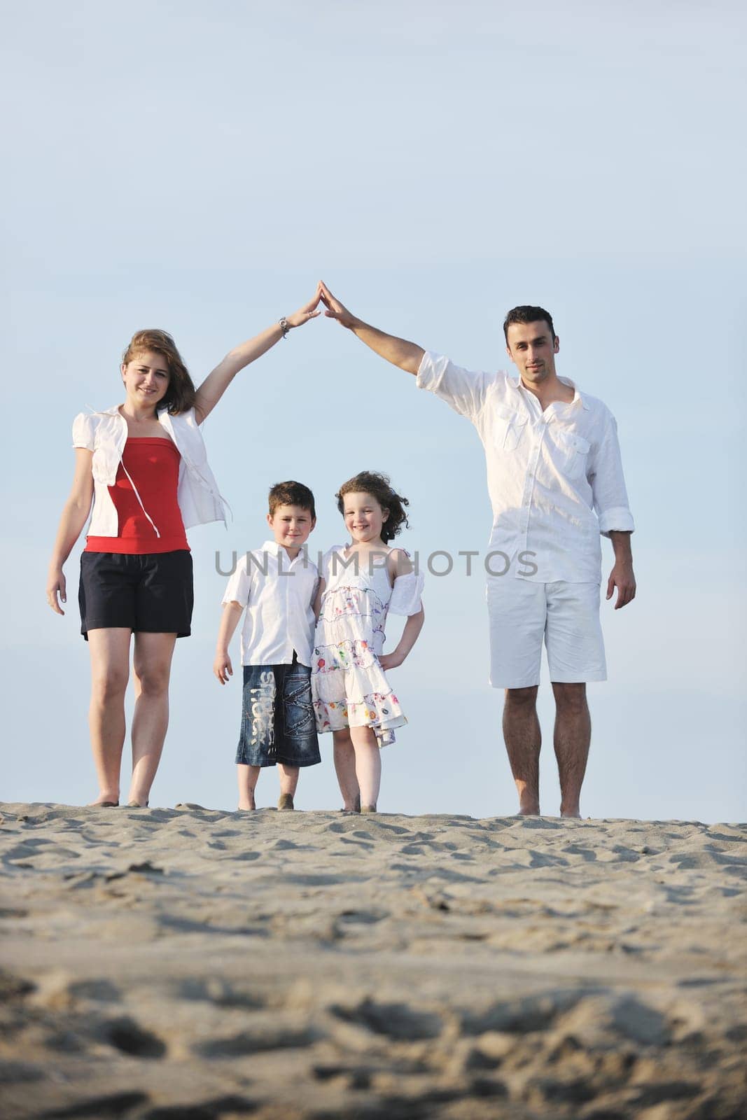 happy young family have fun and live healthy lifestyle on beach