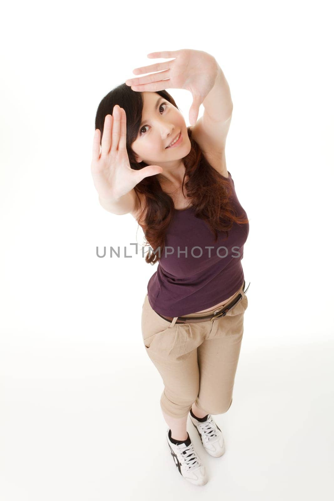 Asian beauty make a frame by hand and looking at you, full length portrait in studio white background.