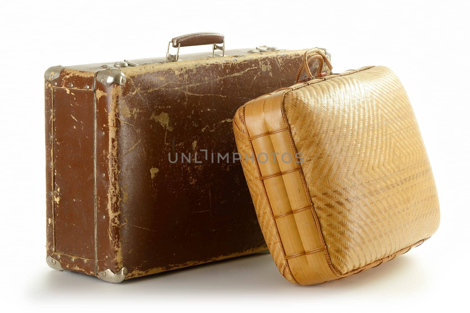 Two old travel suitcases isolated on white