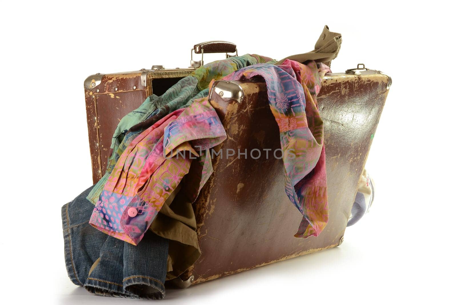 Open old travel suitcese with clothes isolated on white