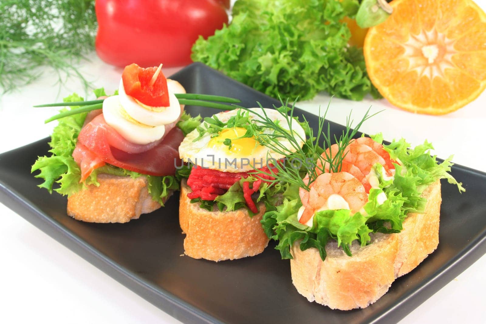 Various canapes against white background