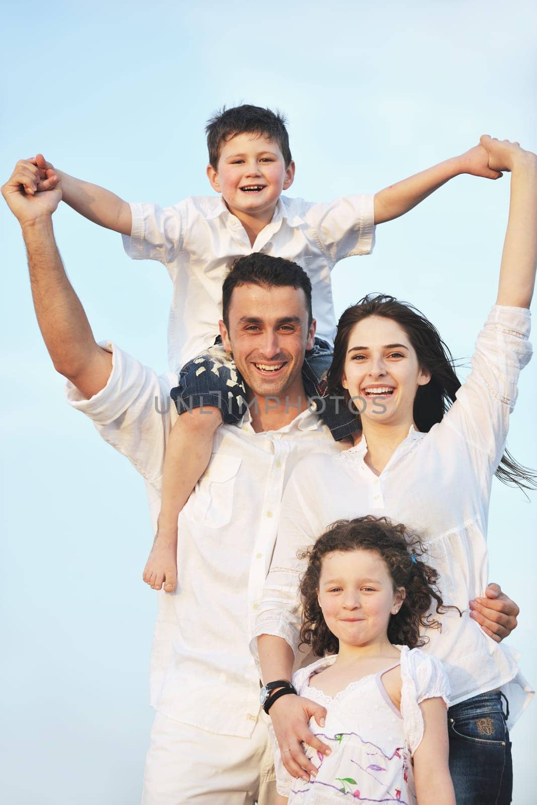 happy young family have fun and live healthy lifestyle on beach