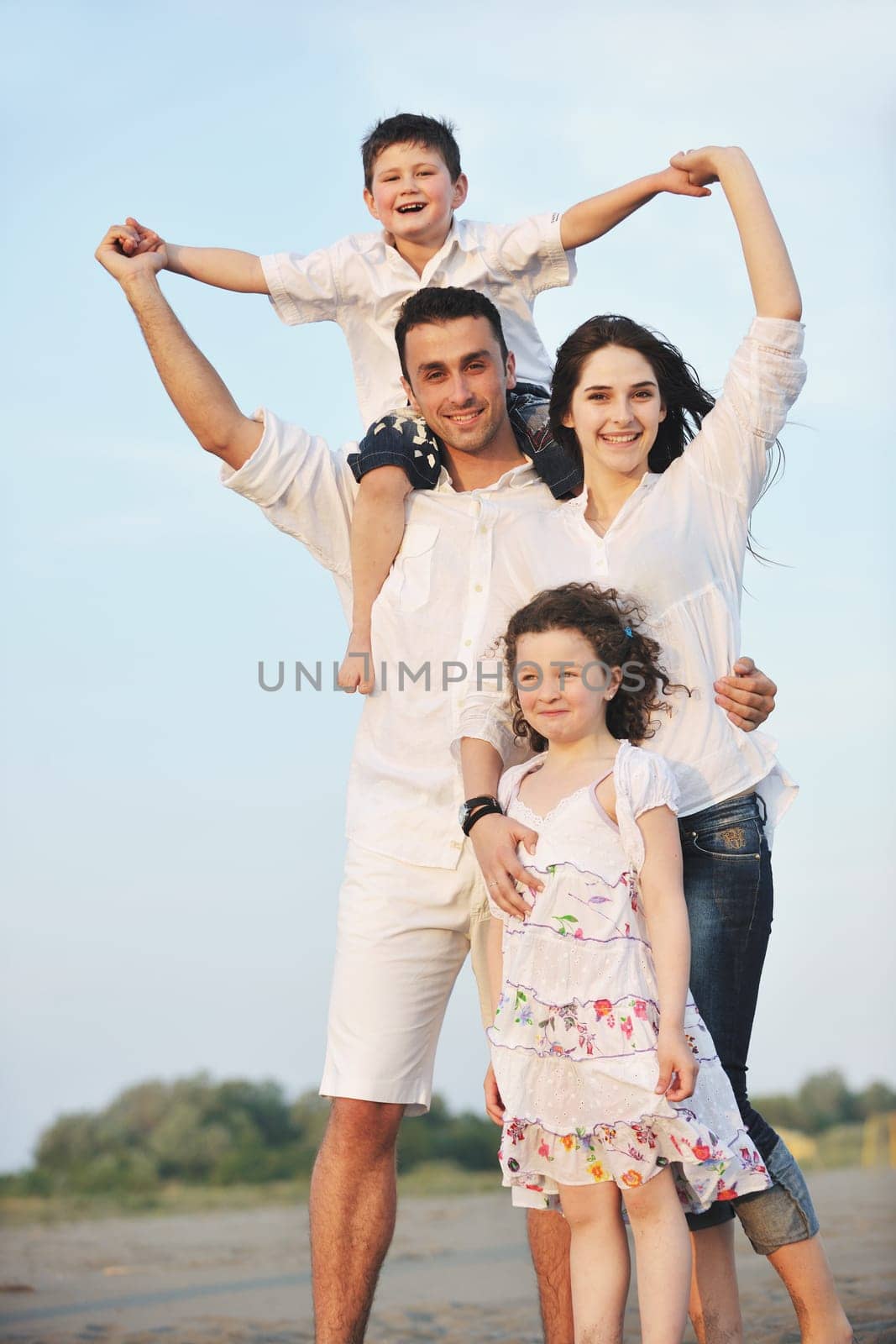happy young family have fun and live healthy lifestyle on beach