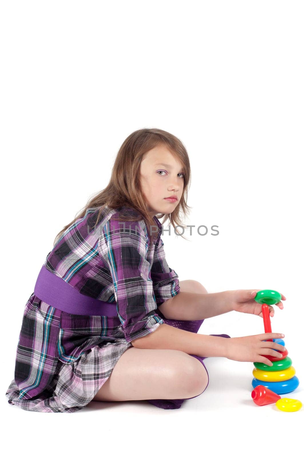 Teenager girl in studio playing in pyramid isolated on white