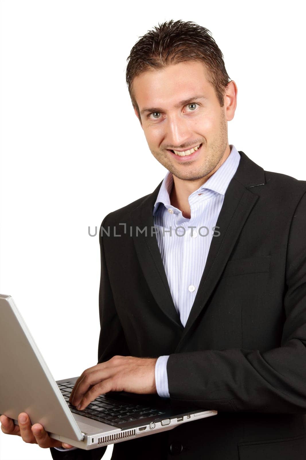 Young businessman with laptop over a white background with copyspace