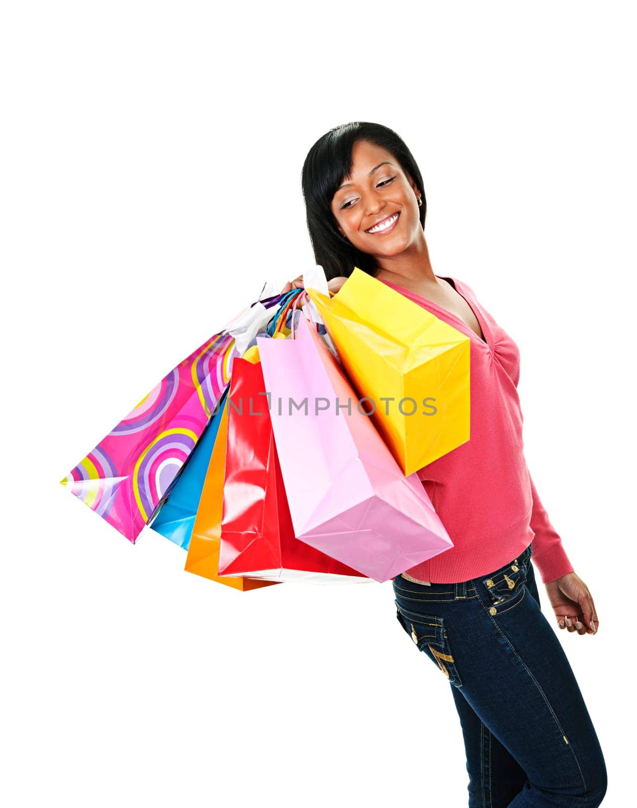 Young joyful black woman holding shopping bags