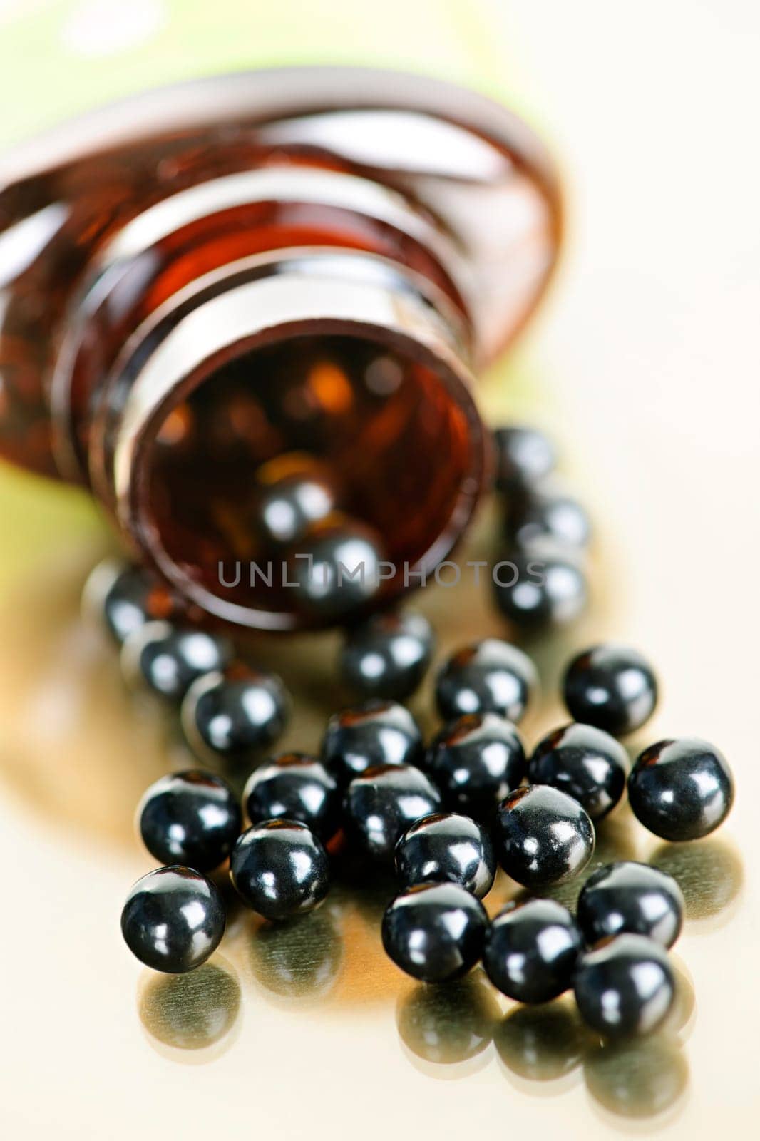 Traditional chinese herbal medicine pills spilling from bottle