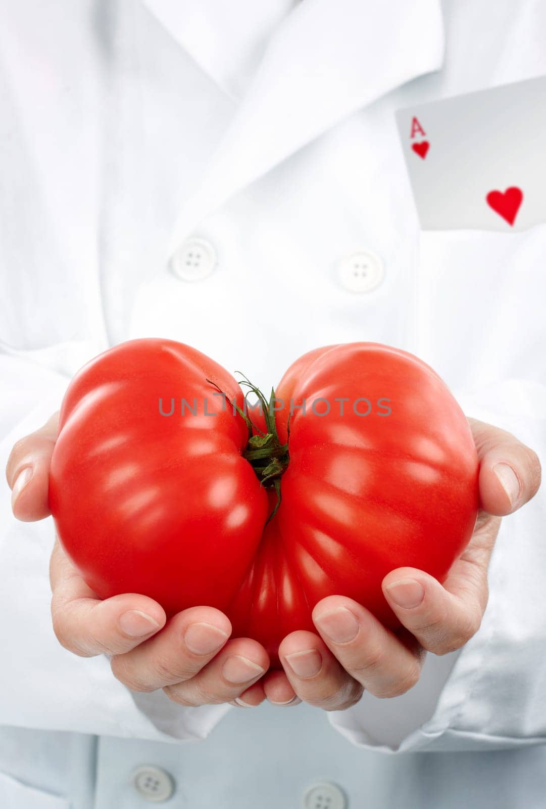 Researcher with the ace in his pocket holding a big sort of tomato