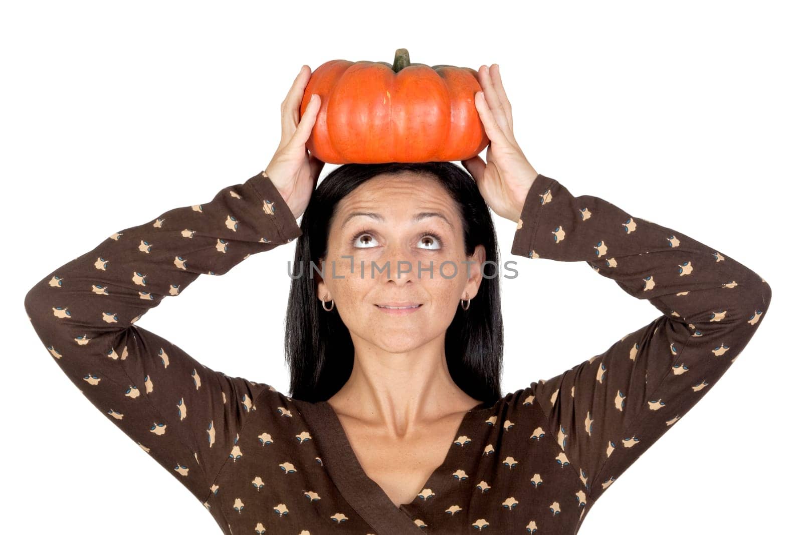 Attractive girl with a big pumpkin isolated on white background
