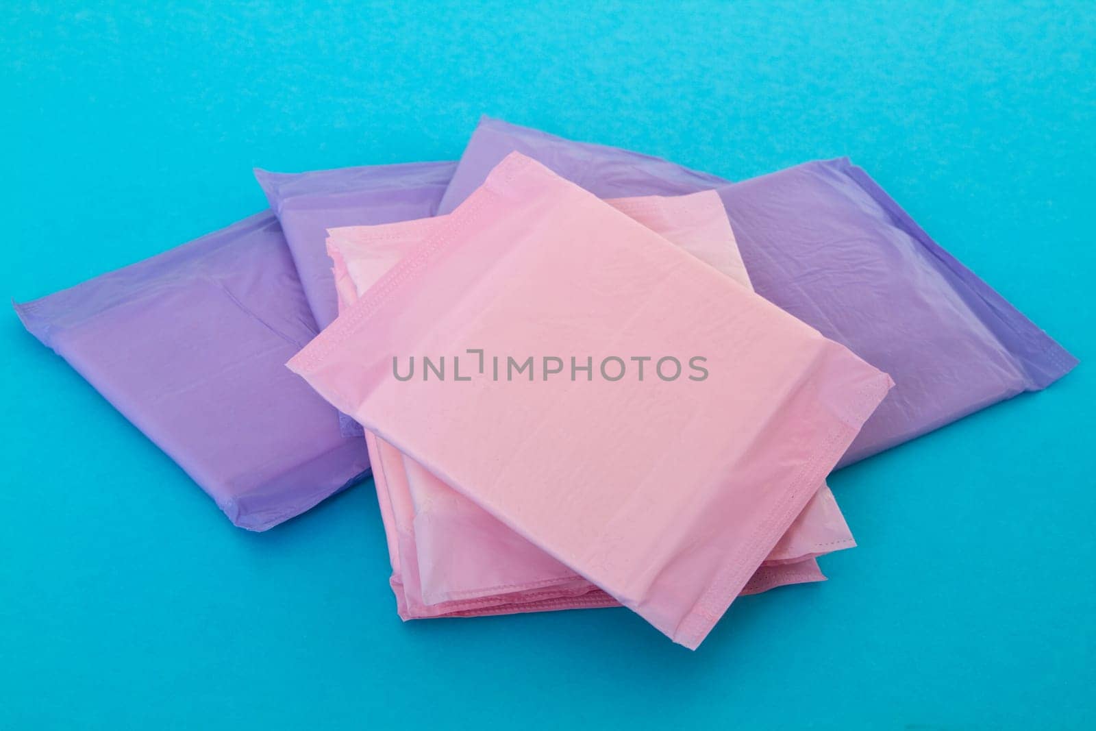 Several sanitary napkins on light blue background