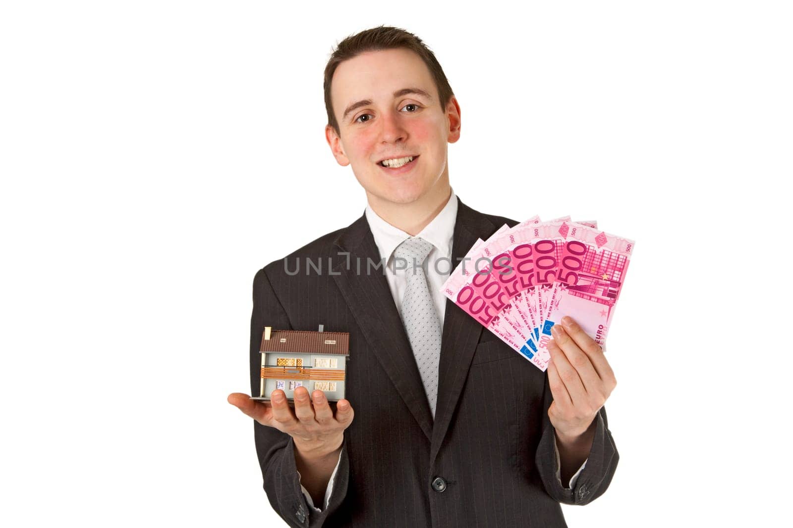 Friendly businessman presenting model house - isolated on white background