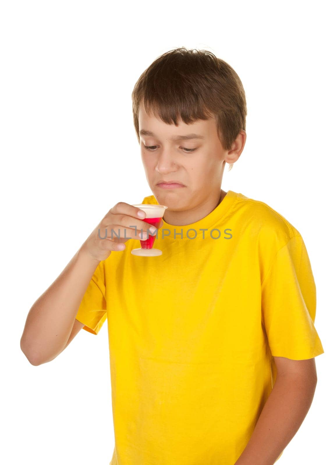teenage boy drinking disgusing cherry medicine