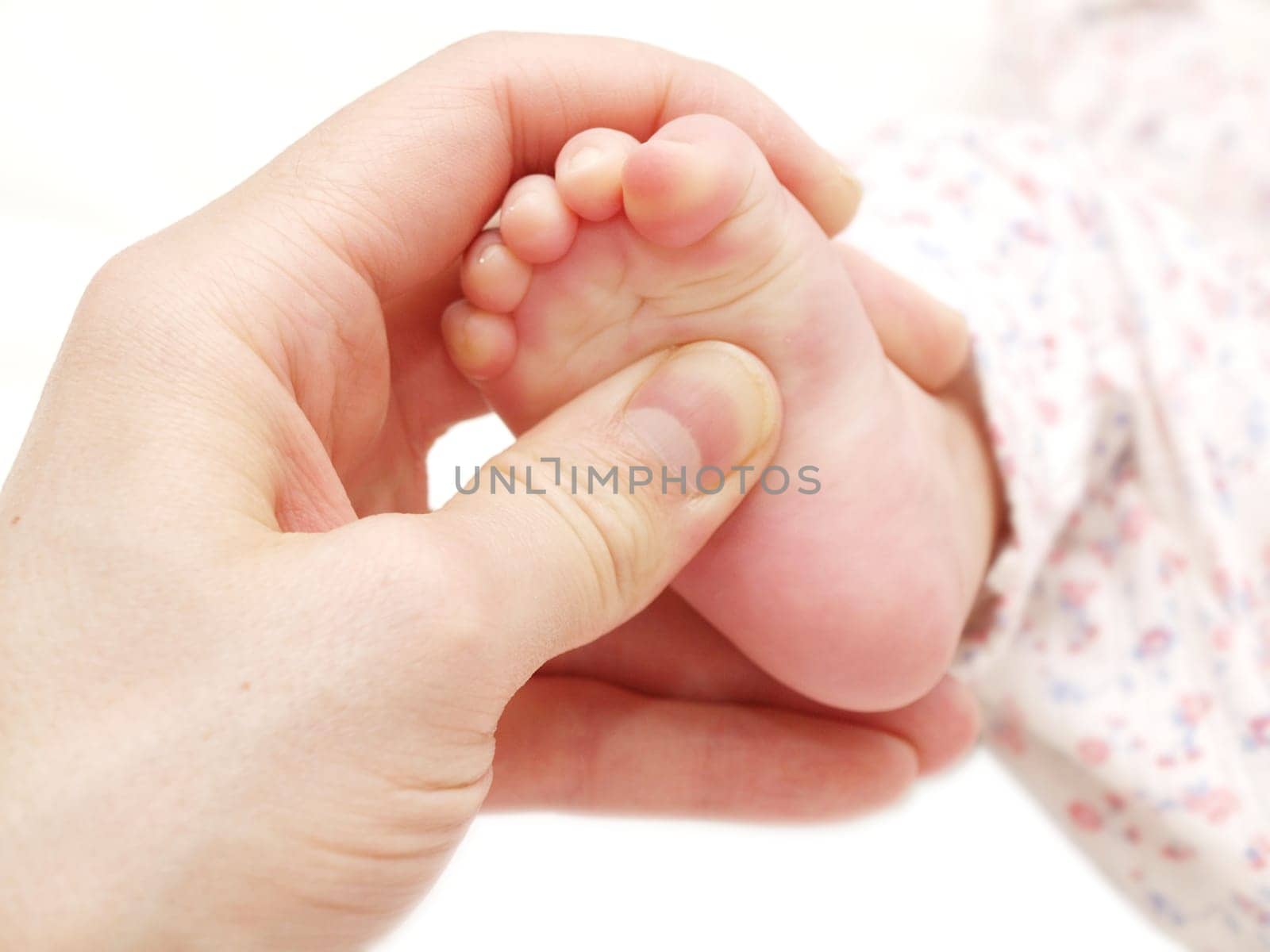 Dermatologist giving baby massage to a babies foot