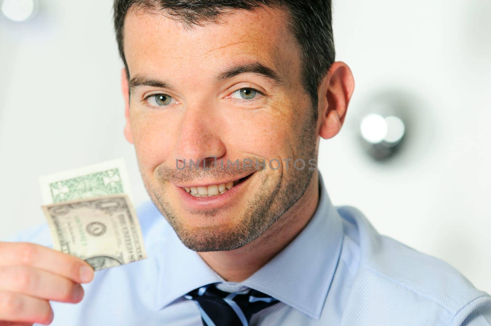 winner and cheerful businessman is showing a dollar
