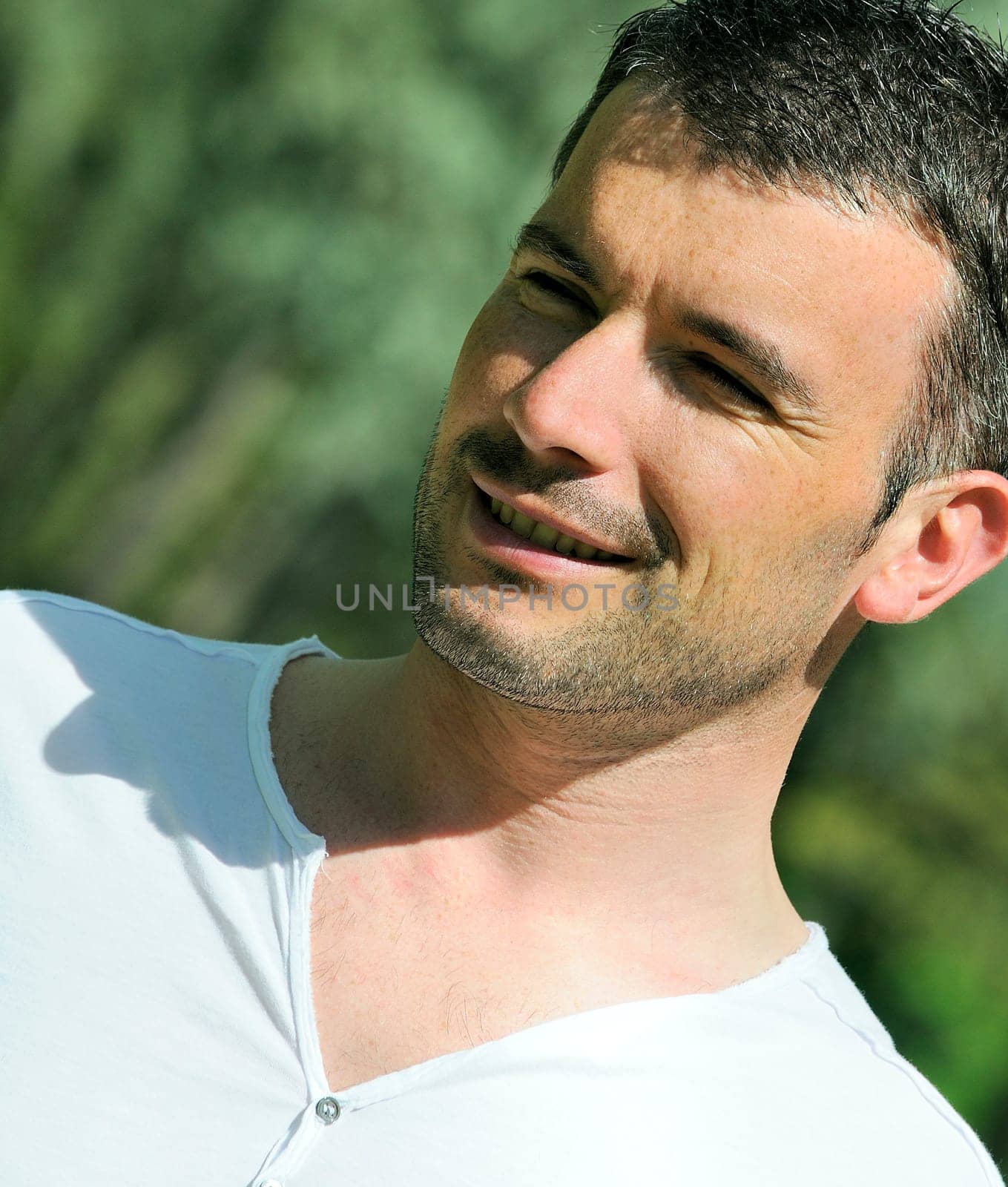 portrait of beautiful man in a natural park