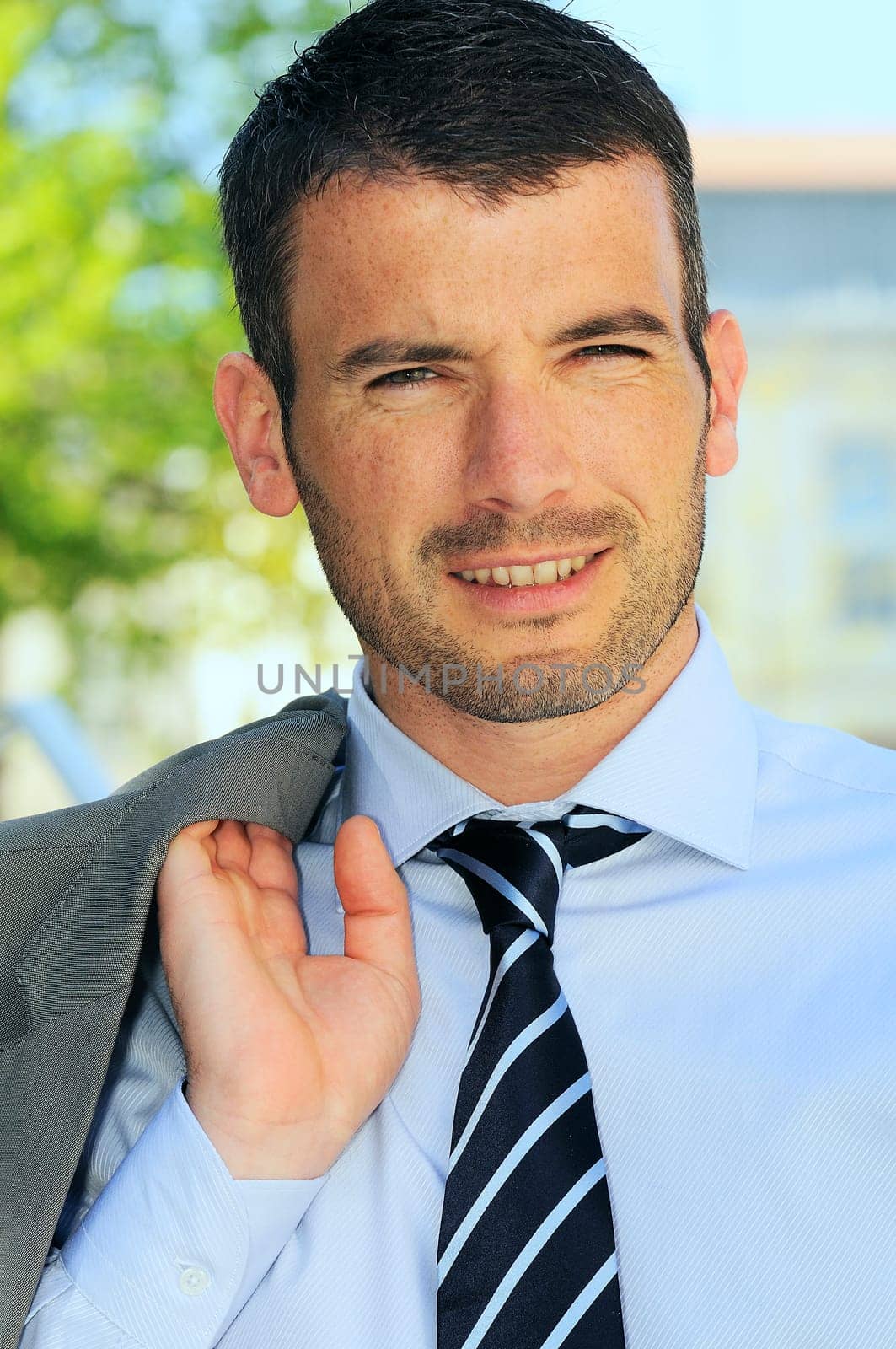 An attractive business man is walking outdoor