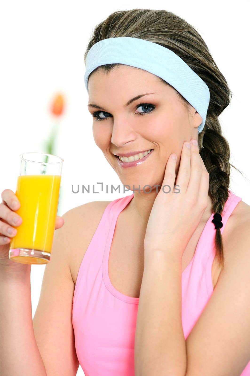 beautiful woman is drinking a fresh orange juice