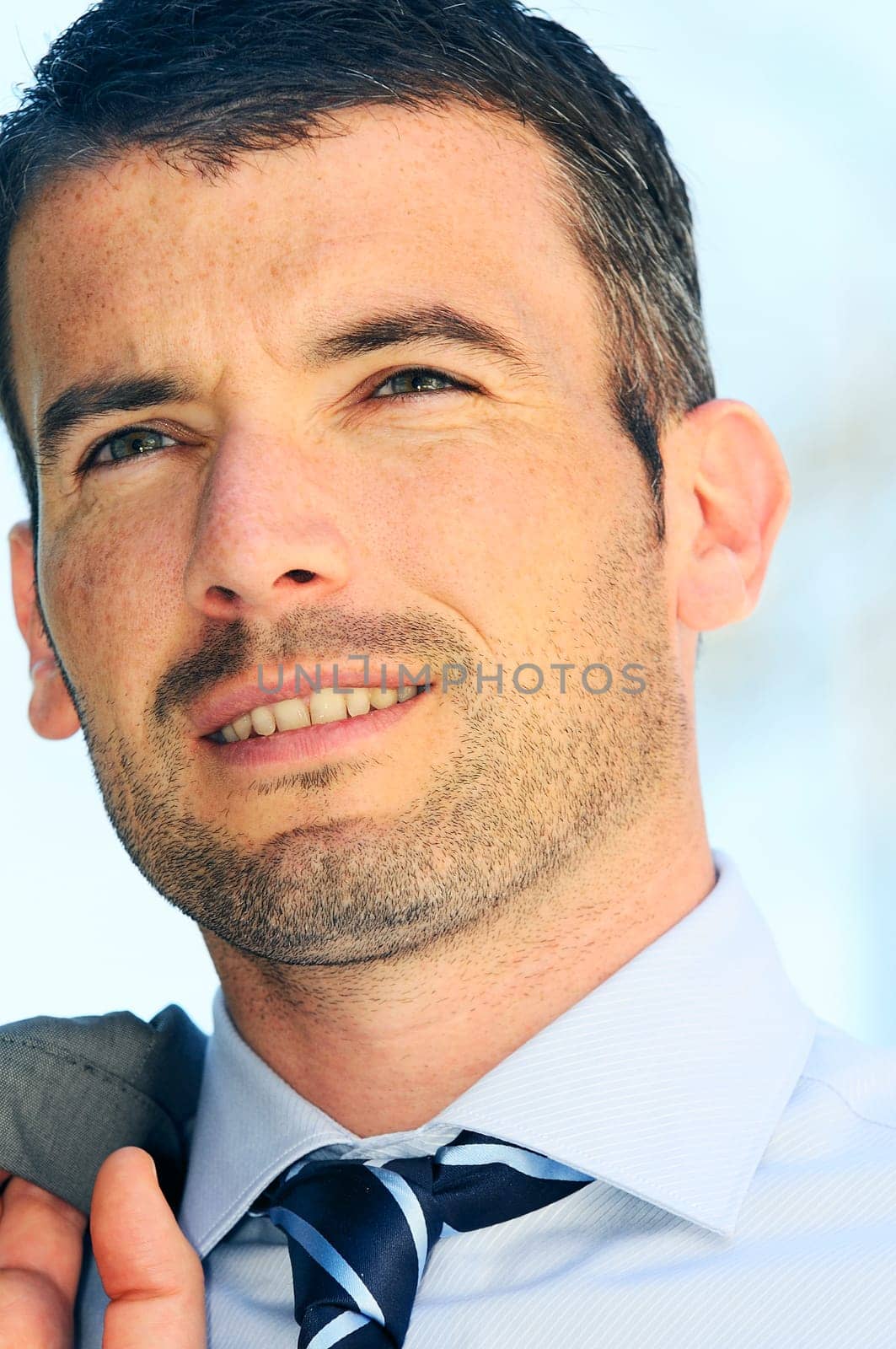 An attractive business man is walking outdoor