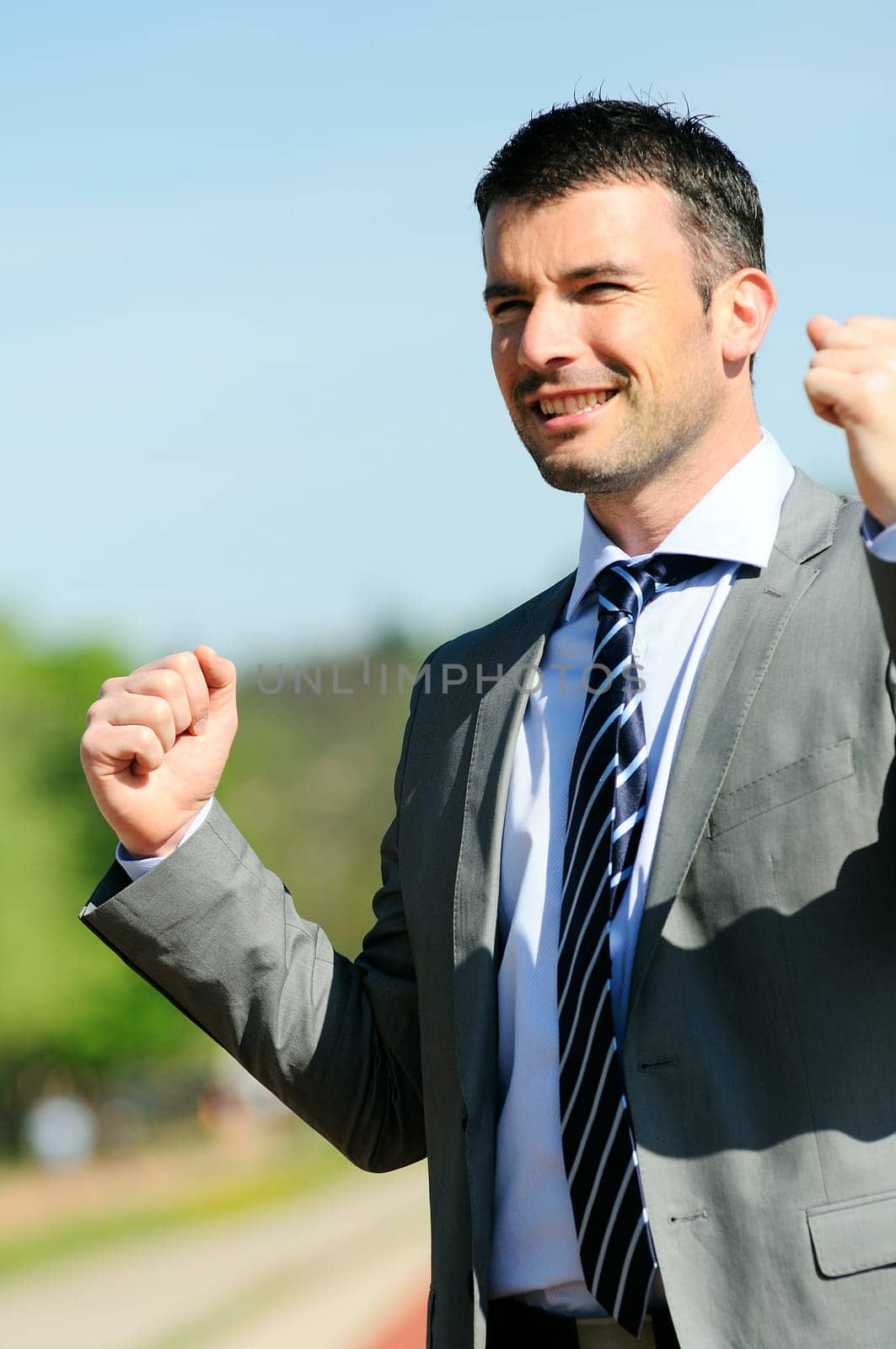 Portrait of a businessman outdoor with winner spirit