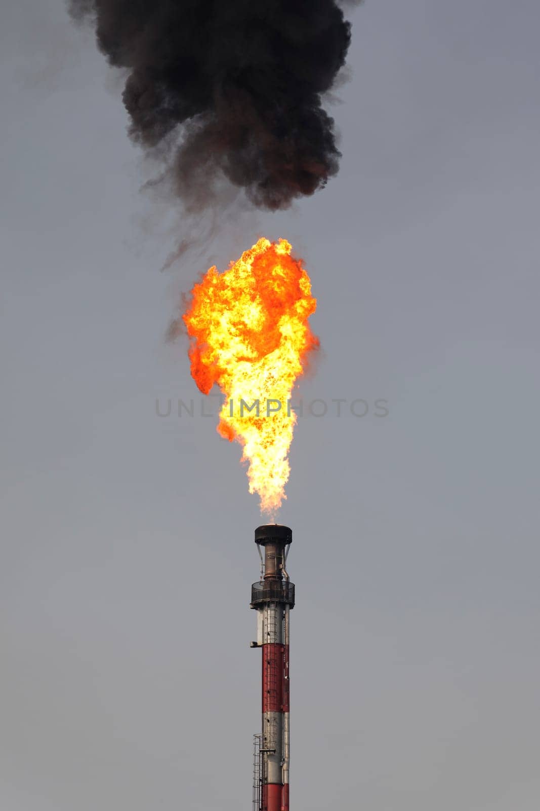 fire of refinery industry with black smoke