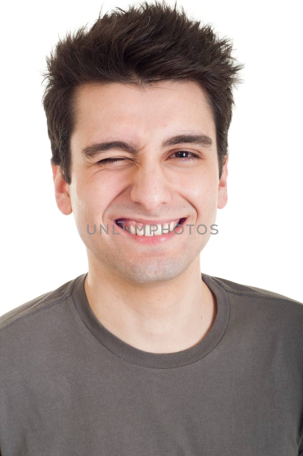 serious young man winking isolated on white background