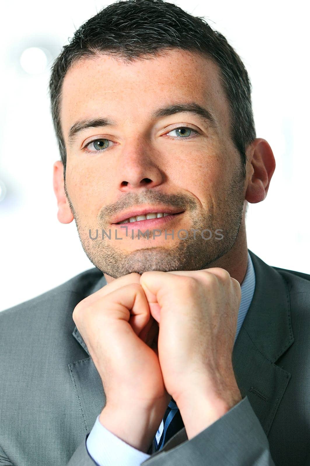 An attractive business man in a light business environment