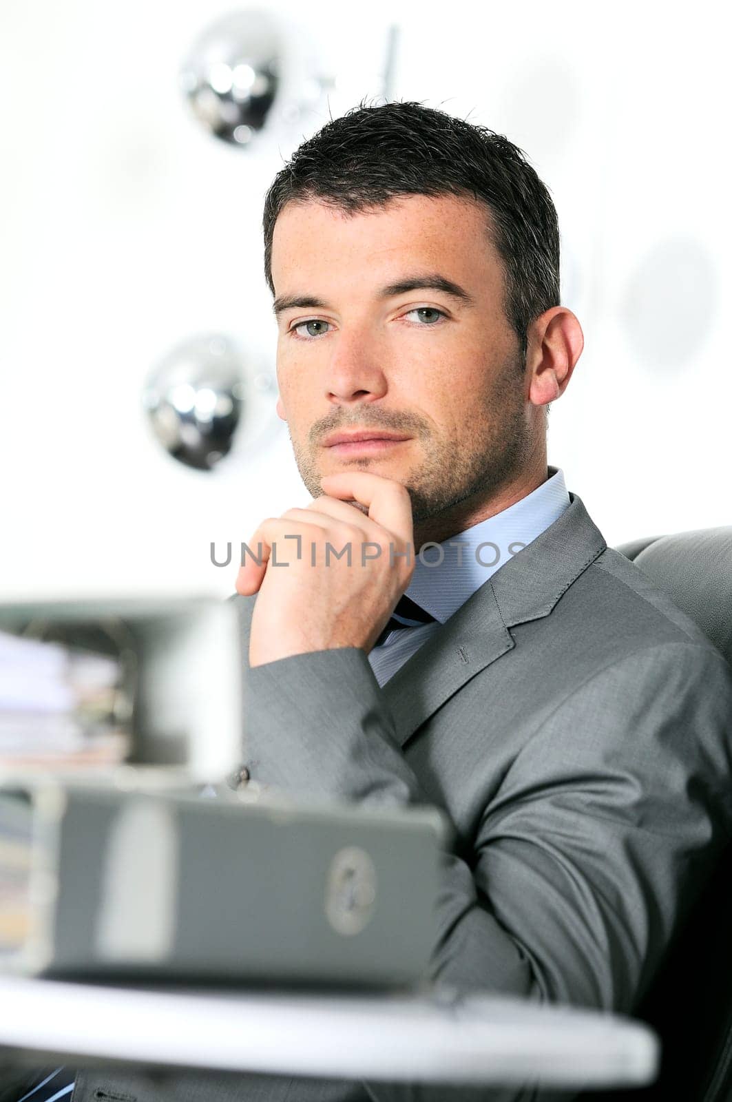 An attractive business man in a light business environment