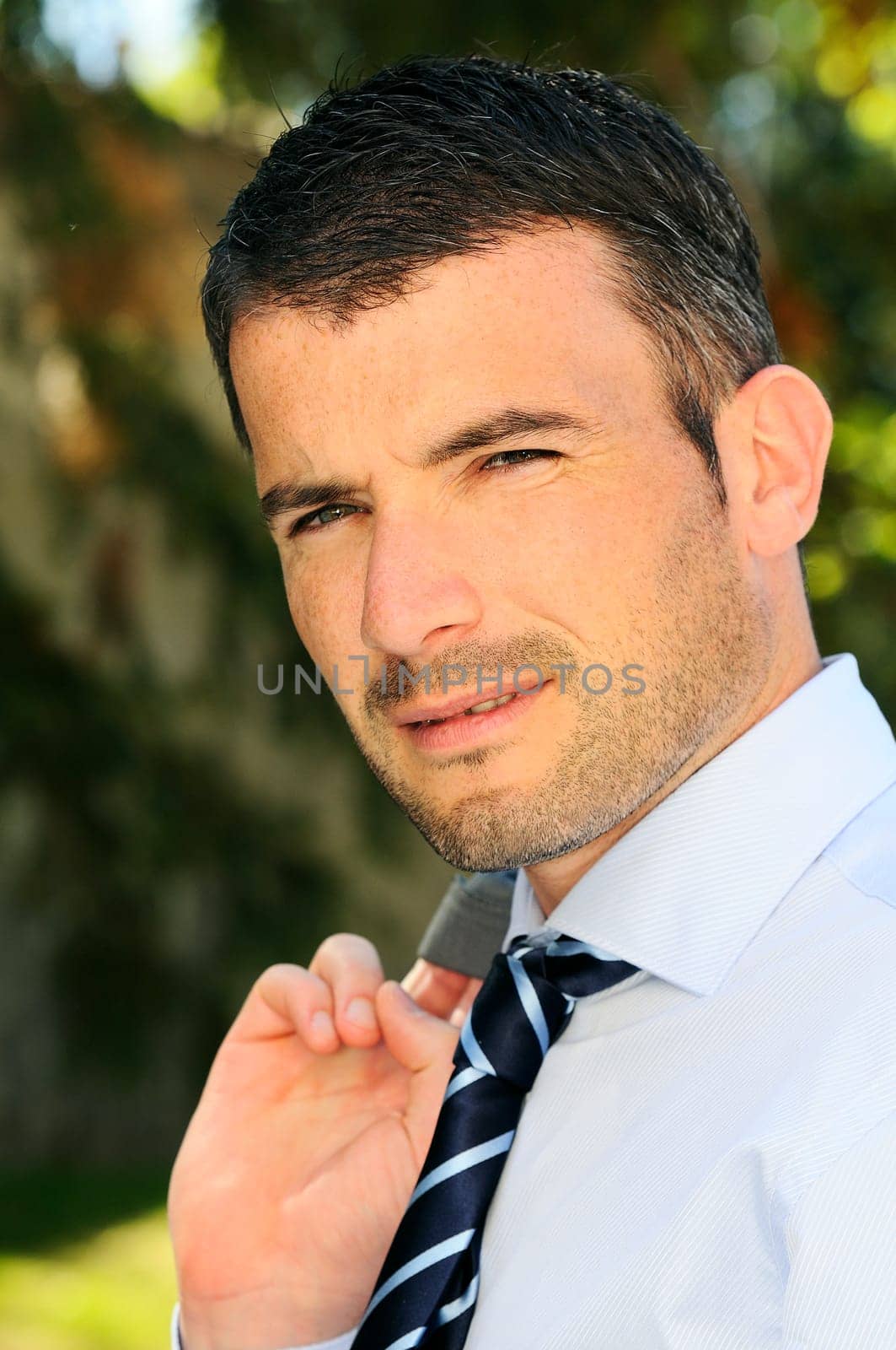 An attractive business man is walking outdoor