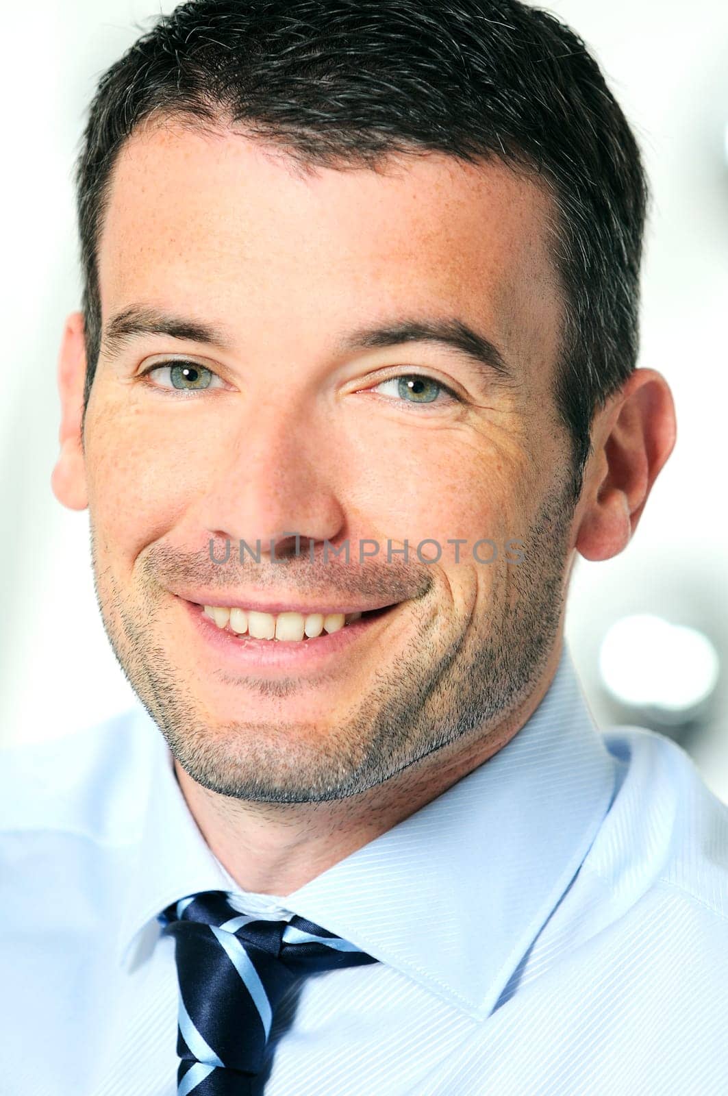 An attractive business man in a light business environment