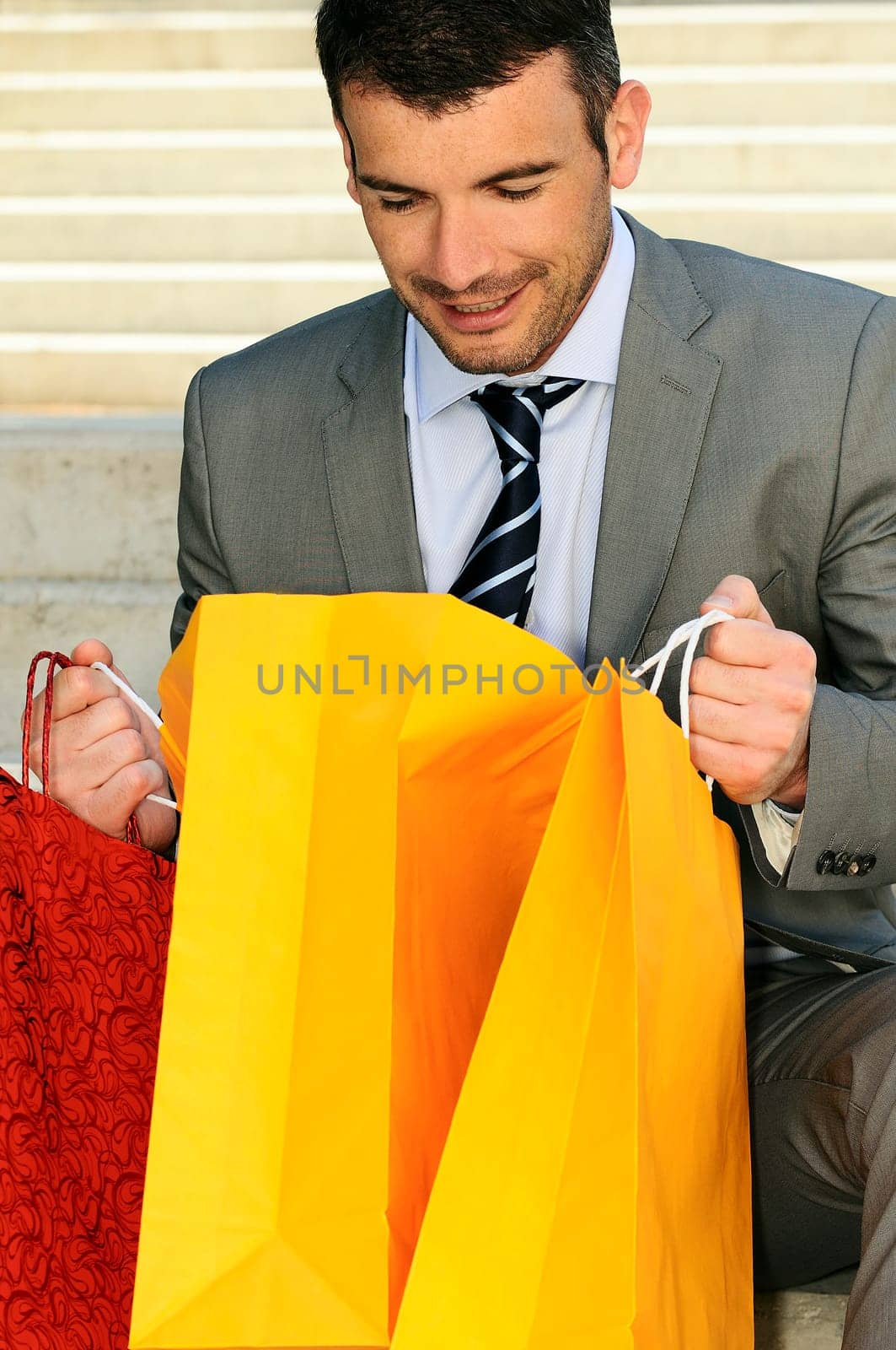 great businessman outdoor with colored shopping bags